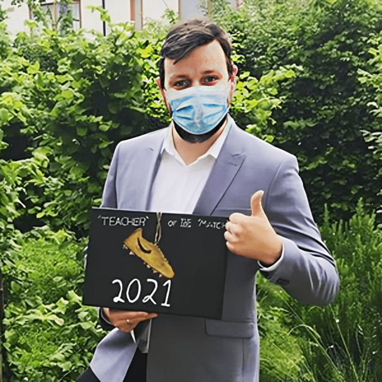 Man in suit displaying 2021 award