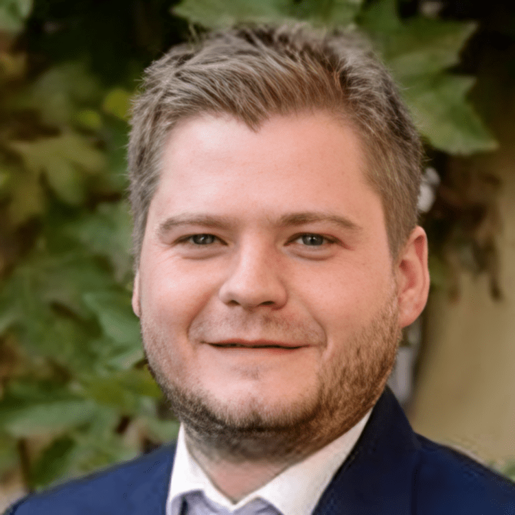Man with short hair, wearing a suit