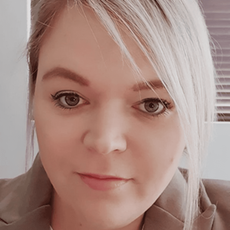 Blonde woman with neutral expression